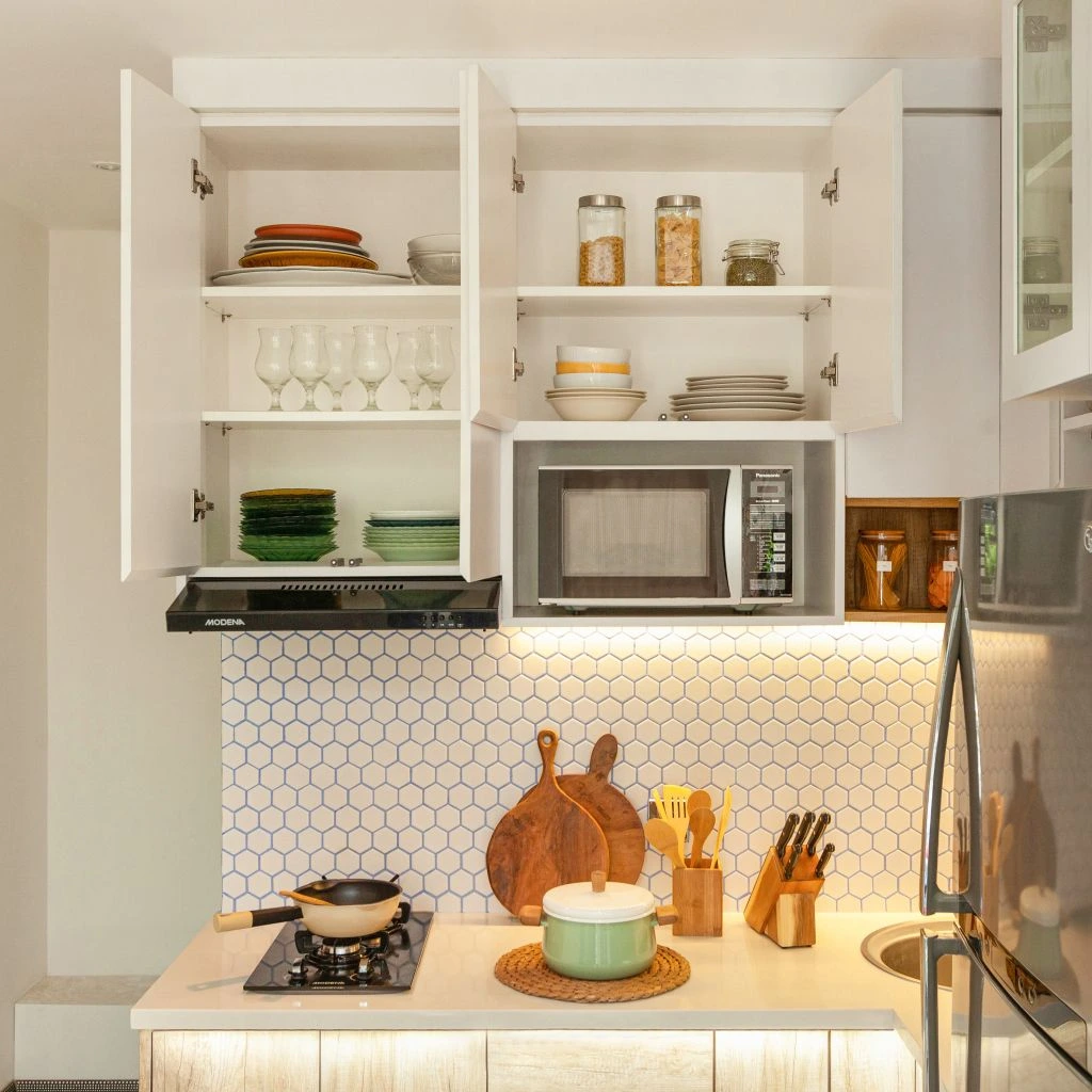 Tiny galley kitchen styled with open shelving and brass.